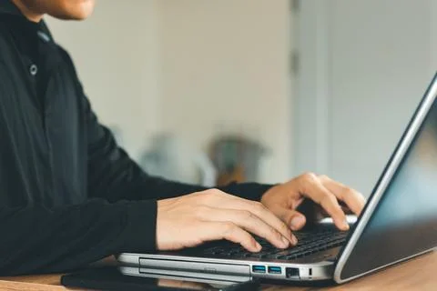 Young man using  laptop computer and  mobile phone When looking for financial Foto stock