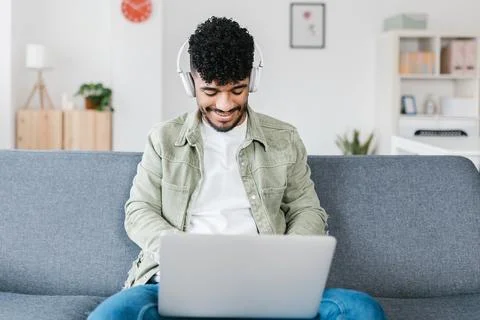 Young man using laptop computer while learning online at home Stock Photos