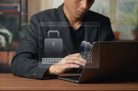 Young Man Using Laptop for Cybersecurity and Data Protection at Desk 写真素材