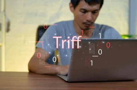 Young Man Using Laptop with Digital Text Displayed in Background Stock Photos