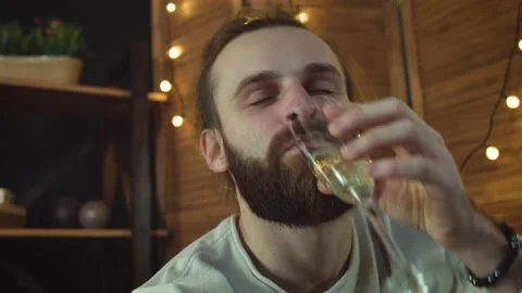 Young man Using Laptop Drink vine. Talking online with friends Stock Footage 147035068