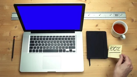 Young man using laptop with green screen at wooden desk. Top view on male hands Stock Footage 82897529