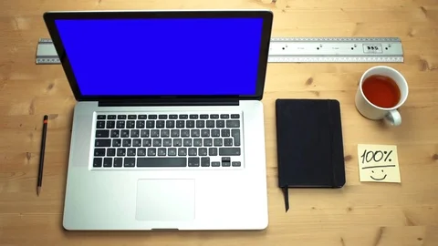 Young man using laptop with green screen at wooden desk. Top view on male hands Stock Footage 82897670