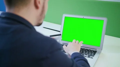 A Young Man Using a Laptop with a Green Screen 스톡 동영상 84767333