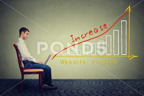 Young man using a laptop has a plan to increase website traffic Stock Photos