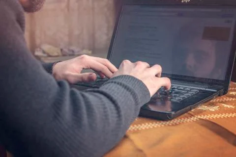 Young man using a laptop in his study room, cropped and close up Stock Photos