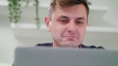 A Young Man Using a Laptop Indoors Stock Footage 83831114