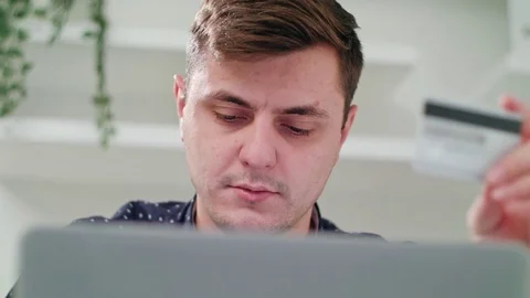 A Young Man Using a Laptop Indoors Stock Footage 83831372