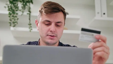 A Young Man Using a Laptop Indoors Stock Footage 83831567