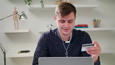 A Young Man Using a Laptop Indoors Stock Footage 83837227
