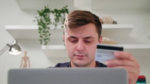 A Young Man Using a Laptop Indoors Stock Footage 83862437