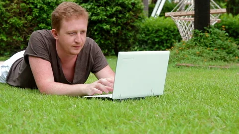 Young man using laptop outdoors Stock Footage 101273384