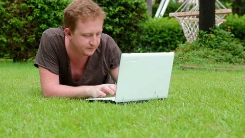 Young man using laptop outdoors Stock Footage 101273415
