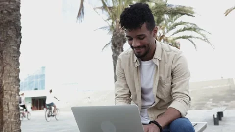 Young man using laptop outdoors Stock Footage 164624159