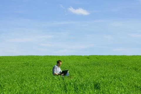 Young man using a laptop outdoors Stock Photos