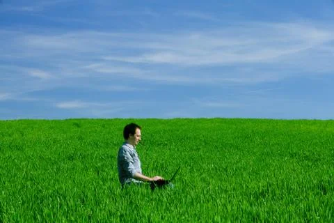 Young man using a laptop outdoors Stock Photos