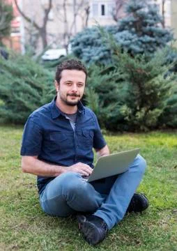 Young Man Using Laptop Stock Photos