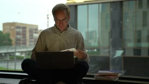Young man using laptop studying online working from home in internet. Stock Footage 132710653