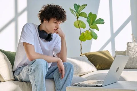 Young man using laptop for video call, online chat conference sitting at home Stock Photos