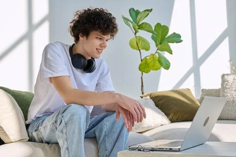 Young man using laptop for video call, online chat conference sitting at home Stock Photos