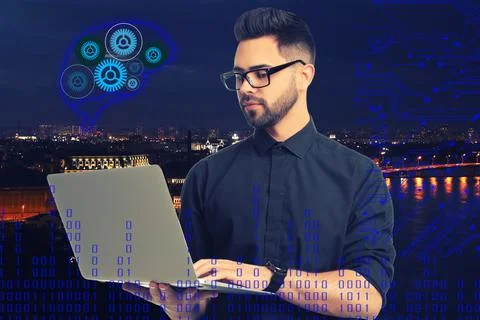 Young man using laptop with virtual image of brain and cityscape on backgroun Stock Photos