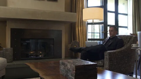 Young man using a laptop while sitting in a suite 動画素材 83392508