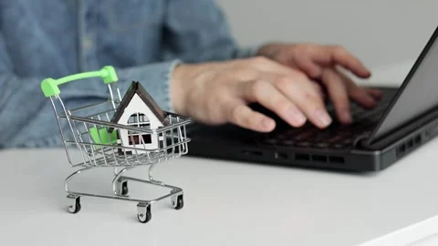 Young man using laptop. Wooden house on the table. Vídeo Stock 275595285