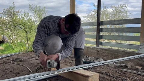 A young man using metal cutting skills to help his Stock Footage 240149548