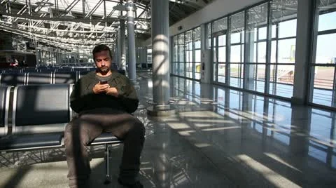 Young man using mobile phone at airport Video stock 12171726