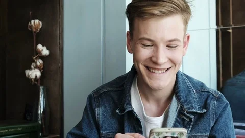 Young man using mobile phone at coffee shop. Stock Footage 85215776