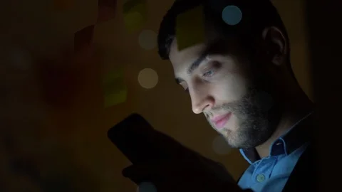 Young man using mobile phone at night in dark office Video stock 88558683