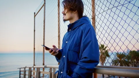 Young man with using mobile phone or smartphone internet 4g app to be up to date Stock Footage 100861150