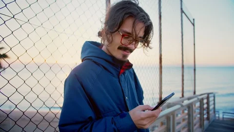 Young man using mobile phone social network news feed be connected to internet Stock Footage 100864064