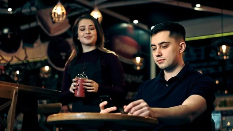 Young Man using Mobile Phone at Cozy Coffee Shop Stock-Footage 108102812