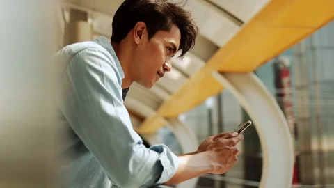 A Young Man Using Mobile Phone in Urban City. Dolly Slider Shot. Slow Motion Stock Footage 122722338