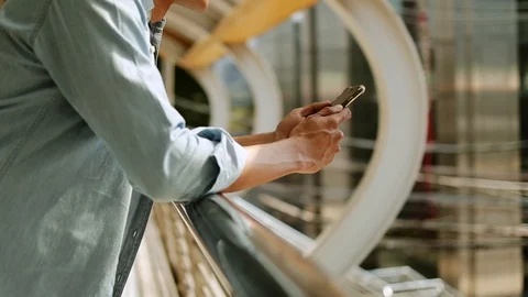 A Young Man Using Mobile Phone in Urban City. Dolly Slider Shot. Slow Motion 库存影片 123148860