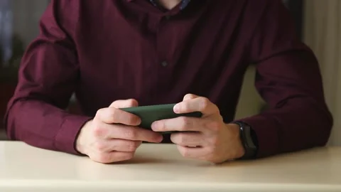 Young man using a mobile phone with on app smartphone, playing in videogames Stock Footage 148043122