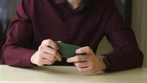 Young man using a mobile phone with on app smartphone, playing in videogames Stock Footage 148043151