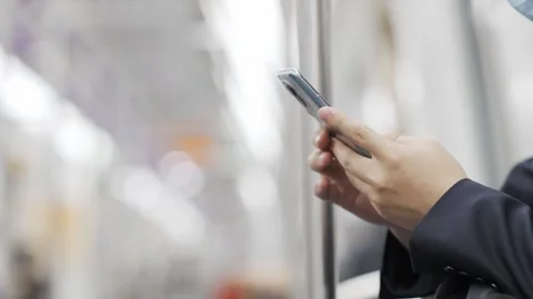 Young man using mobile phone in subway Stock Footage 195080748