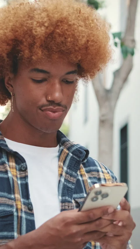 Young man using mobile phone outside Stock Footage 250843830