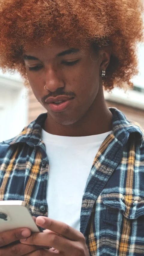 Young man using mobile phone outside Stock Footage 255965660