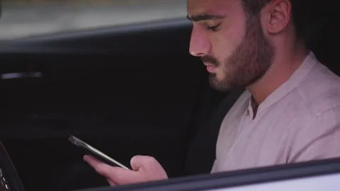 Young Man using mobile phone sitting in car Stock Photos