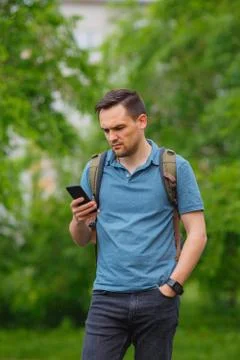 Young man using mobile phone in the forest while hiking Stock Photos