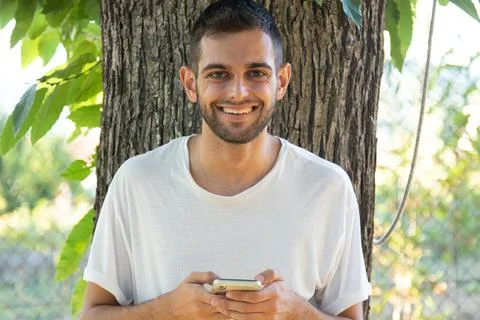 Young man using mobile phone outdoors Foto stock