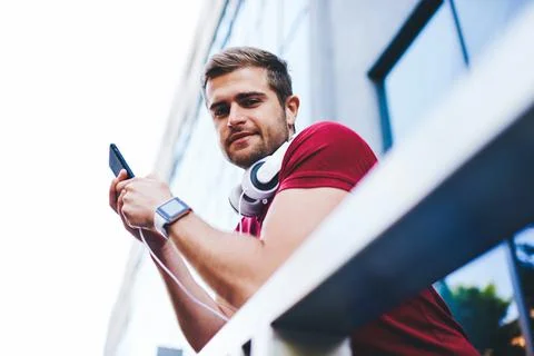 Young man using mobile phone on balcony Stock Photos