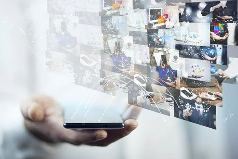 Young man using modern mobile phone to switch pictures Stock Photos