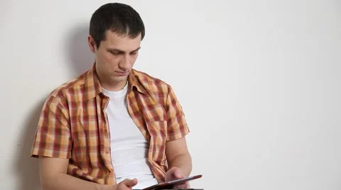 Young man using a pad and going away Stock Footage 60064168