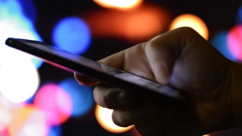 Young man using phone for communication. phone message in a night city. Video stock 219856798