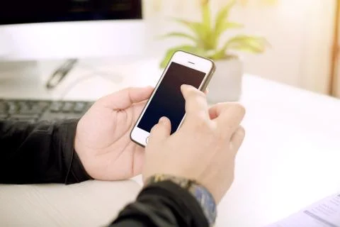 A young man is using the phone in hand Stock Photos