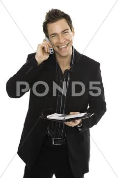 Young man using phone, holding schedule Stock Photos